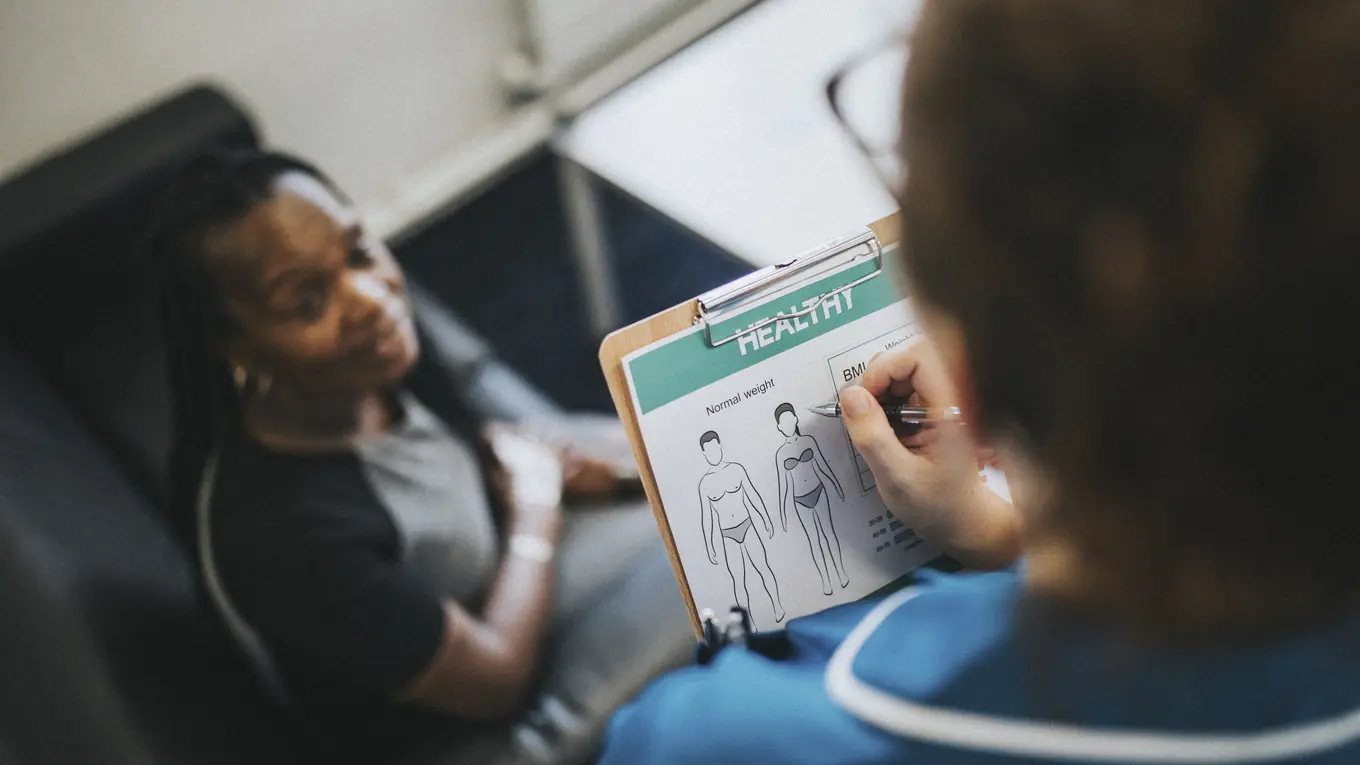 Doctor consulting patient about health and weight