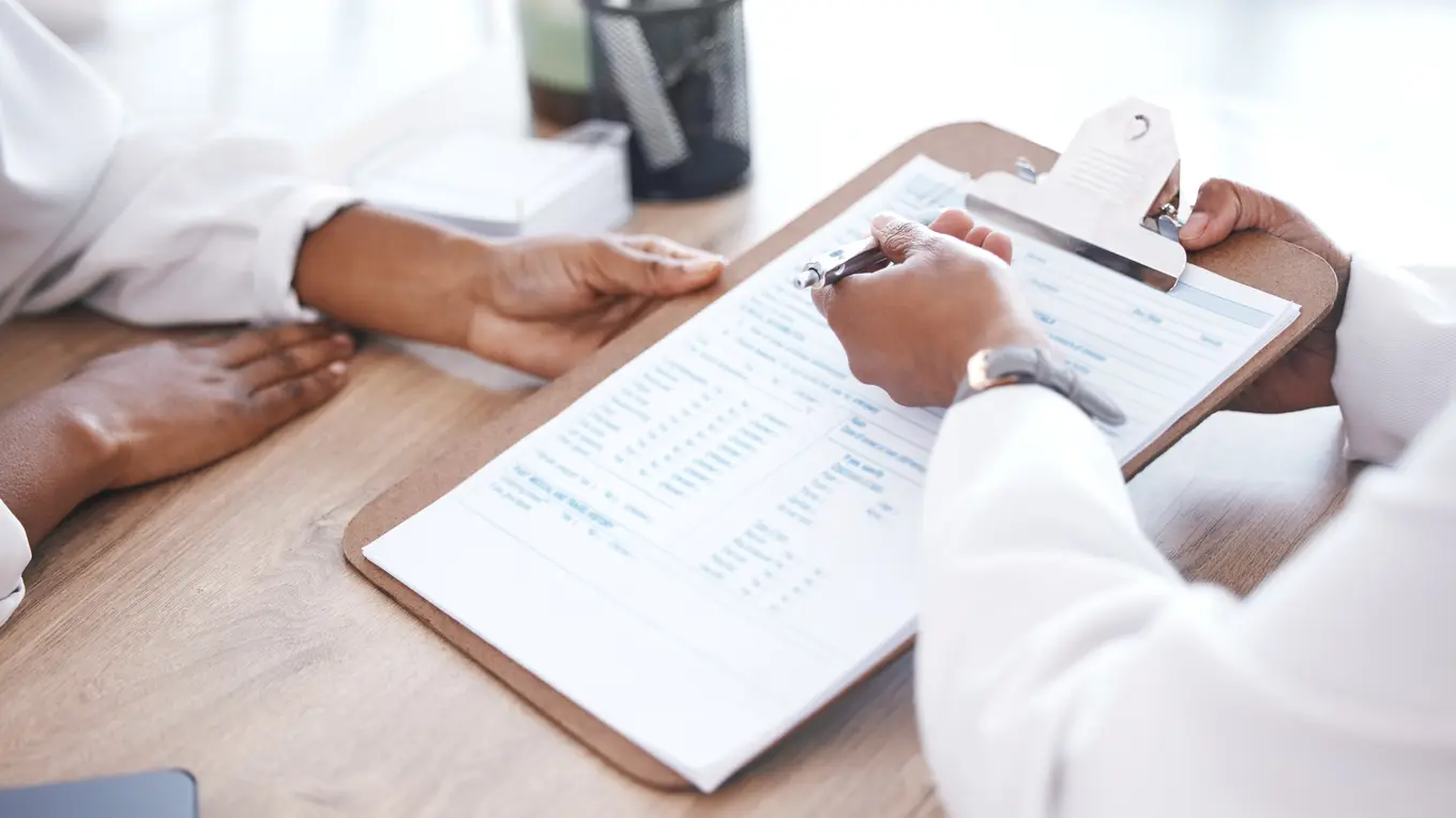 Doctor and patient reviewing medical form