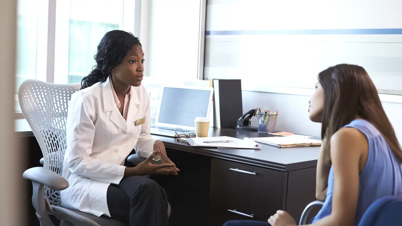 Doctor consulting with patient in office